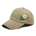 Detail of khaki cotton baseball cap showing white daisy flower embroidery on the side - One Size / Khaki