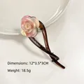 Pinza para el pelo de acetato marrón con rosa grande y dimensiones detalladas - Iridiscente