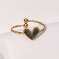 Macro shot of gold heart ring with hammered texture and black enamel center detail - Pearlescent Black