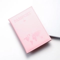 Detail shot of pink PU leather passport cover with world map embossed pattern - Pink