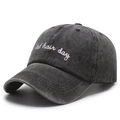 Close-up of pink bad hair day embroidery on washed black cotton baseball cap - One Size / Black