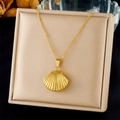 Detailed view of a gold shell pendant necklace with pearls on a jewelry box lid - 3D Shell Pendant With Bead Chain (N3482)