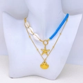 Double-layered gold necklace featuring white shells, blue beads, and starfish charms - Starfish & Scallop