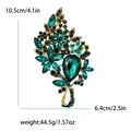 Large vintage gold brooch with green crystals and pear-shaped stone, size 10.5x6.4cm - Green