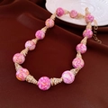 Macro view of vintage pink marble beads with gold rhinestone accents and extension chain - Necklace / Pink