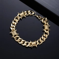 Detail of a gold Cuban link bracelet with barbed wire elements and lobster clasp closure - 22cm / Gold Bracelet