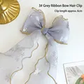 Grey snowflake ribbon bow hair clip with gold trim and 6cm spring fastener - Grey Streamer Bow Hair Clip (A190-11)