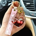 Creative pink quicksand heart keychain with liquid red sequins and a golden bell charm - Red