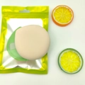 Beige round makeup puff with green spacer in yellow resealable foil packaging - Marshmallow Green (XL) Bagged