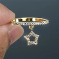 Elegant gold star pendant ring with sparkling pavé diamonds shown on finger - US 7 / Gold