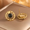 Macro shot of vintage gold twist earrings with black marble stone on luxury leather box - Gold + Black Turquoise