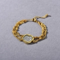 Macro view of woven gold chain bracelet with silver coin pendant and vintage textures - 1PC Gold Bracelet