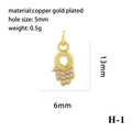 Macro detail of 18K gold plated Hand of Fatima pendant with zircon and 5mm hole - Gold Hamsa Hand H-1