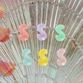 Close-up of colorful translucent resin S-shaped beads for DIY hairpins and accessories - Letter S