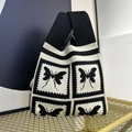 Knitted tote bag featuring black and white patchwork with woven butterfly patterns - Black and White Butterfly