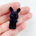 Handheld view of a cute black flocked rabbit pendant for DIY crafts and accessories - Black Rabbit