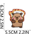 Detail view of the embroidered capybara patch showing 6.3cm by 5.5cm measurements - Flame Background