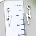Set of two silver lightning bolt alloy pendants showing a length of 2.5cm on a ruler - Small Lightning Bolt (22345) / 1 Piece (20x5mm) / Antique Silver
