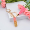 Pink tassel keychain with golden resin letter I charm and gold foil flakes detail - Letter I