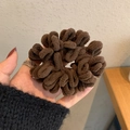 Dark coffee plush hair scrunchie with thick chenille texture held by hand - Coffee