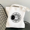 White canvas tote bag featuring a black sun and moon print on a vintage minimalist chair - STD438-J (Black Line Sun Moon Stars)