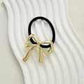 Minimalist black elastic hair tie with a polished golden metallic bow accessory - Bowknot Style