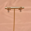925 silver flower stud earring with natural freshwater pearl on golden display - Flower Stud Earrings