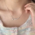 Elegant gold choker necklace with curved pearl bar and star pendant on model - Pearl Row Star Style (XL2535)