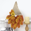 Detail of fall gnome with burlap hat and autumn maple leaf beard on light background - Leaf