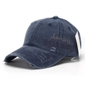 Detail of navy blue washed baseball cap featuring side embroidery and distressed ripped fabric - Dark Blue