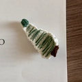 Close-up of hand-knitted Christmas tree hair clip with white and green yarn details - Christmas Tree - White & Green