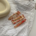 Detailed view of three resin hair clips with cream base and red confetti accents - Sakura 3Pcs Set - Chinese Red