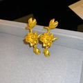 Macro detail of vintage gold lotus earrings with matte finish on grey velvet stand - Single Left Ear / Gold