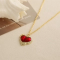 Vintage gold necklace featuring a red enamel heart pendant on shell and card background - Red Heart Gold Border
