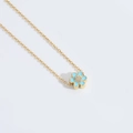 Minimalist gold necklace featuring light blue flower pendant with white cubic zirconia - Blue