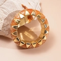 Close-up of geometric stretch bracelet with gold metal and orange marbled resin triangles - Brown