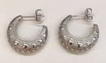 Detail of silver C-shape stud earrings with textured heart patterns and metal finish - Silver Heart Embossed Style (AE41826A0W0)
