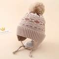 Close-up of winter knit boy hat with jacquard pattern and soft fur pompom on white stand - One Size (3-8 Years) / Khaki