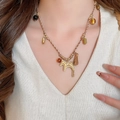 Ethnic woven necklace with a gold pony pendant and colorful tassels on a fashion model - 23# Necklace Gold Coffee Ethnic Style