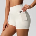 Close-up of functional side pocket on cream high-waisted yoga shorts with phone - Light Ivory