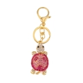 Golden turtle keychain with vibrant pink and red rhinestones on a white background - Pink