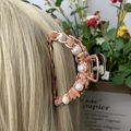 Rose gold hair claw clip featuring pink crystals and white pearls on golden hair - Sunstone + Deep Sea Pearl Rose Gold Hair Claw