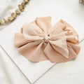 Close-up of beige multi-layer fabric and chiffon bow hair clip on a minimalist background - Khaki Pleated
