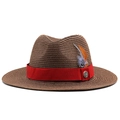 Detail of woven straw hat featuring red ribbon and feather with golden emblem - M (56-58cm) / Brown