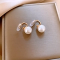 Detail of elegant gold earrings with white pearls on a brushed metal surface - Clip-on - Gold - White - 10mm