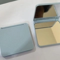 Mini square folding double-sided makeup mirror in light blue with matte finish - Blue