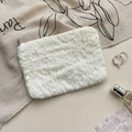 Detail of white chiffon floral pouch with 3D texture and gold zipper closure - White