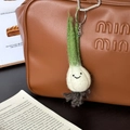 Handmade wool felt garlic pendant with smiley face hanging on a brown leather bag - Clever Scallion