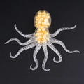 Octopus squeeze toy with golden beads inside on a black background for stress relief - Header Card Pack / Yellow Beads