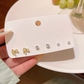 Three-pair gold earring set featuring bowknot, clear zircon, and white pearls on card - Bowknot Pearl Combo